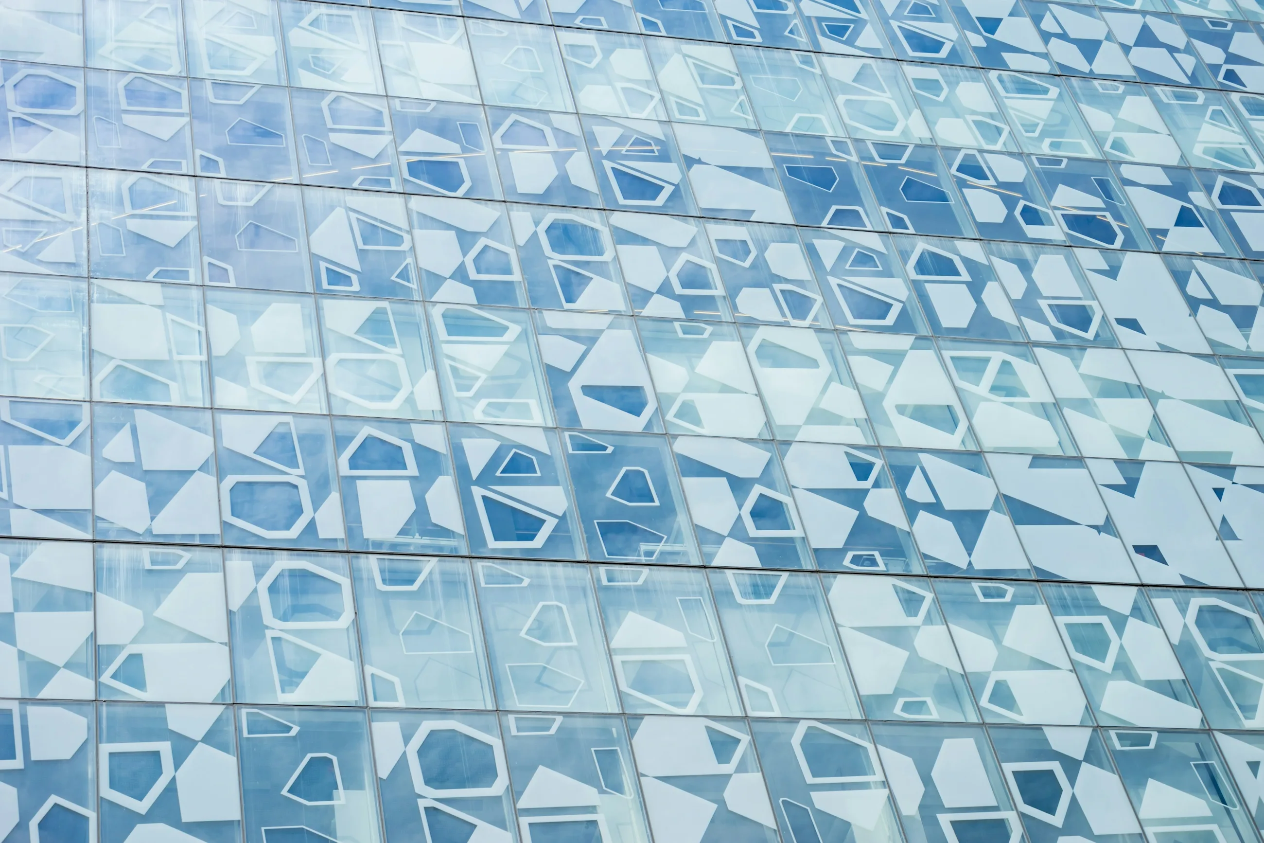 Blue glass facade with geometric window pattern